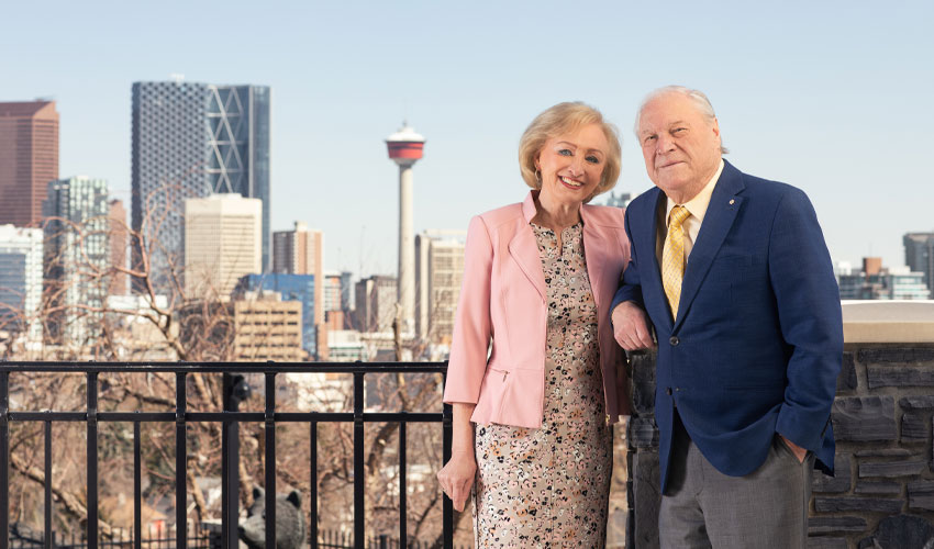 Don and Ruth Taylor standing side-by-side with the City of Calgary in the background.