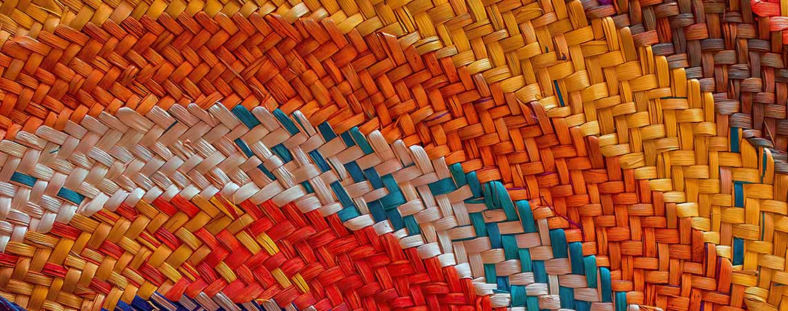 Close up of a colourful woven hat.