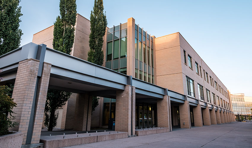 Photo of the East Arts building from East Gate - a building of peach bricks with a covered overhang.