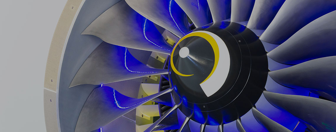 Close up of a jet engine with blue lights illuminating the intricate details of the machinery.