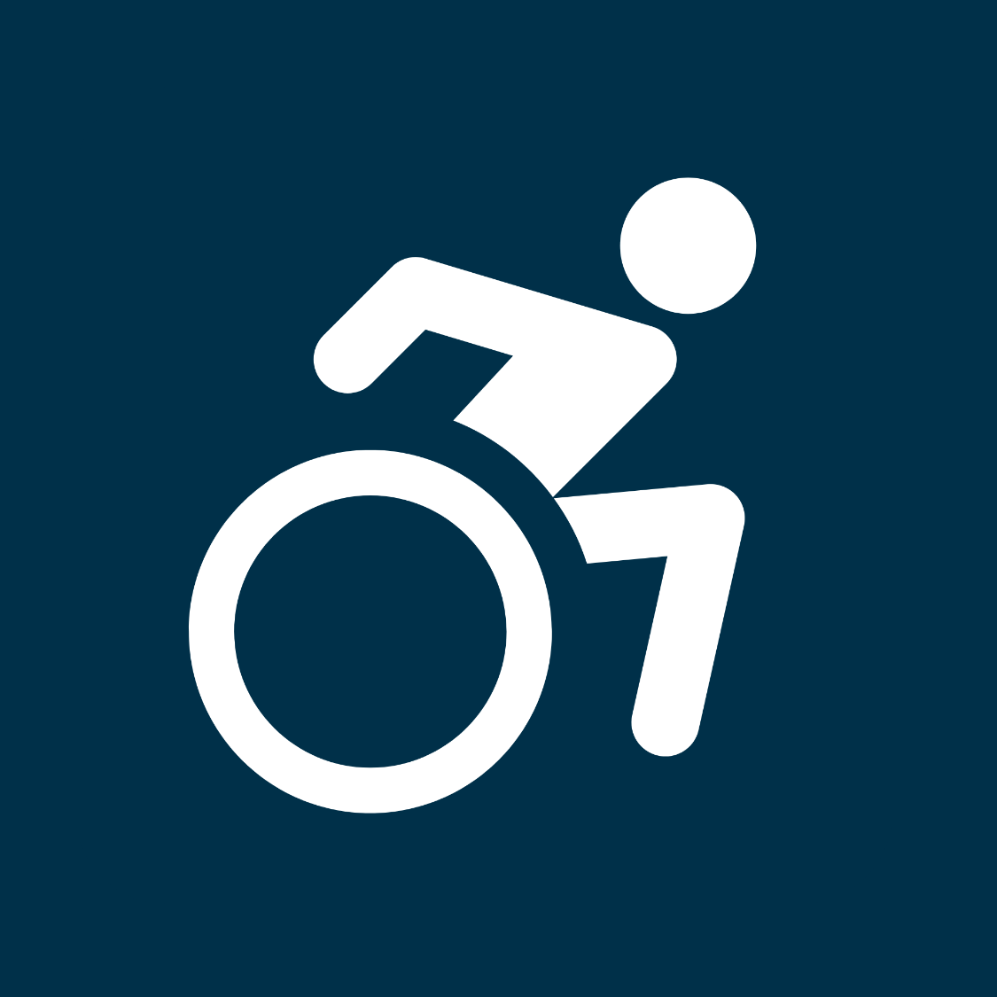 Icon of a person pushing themselves in a wheelchair