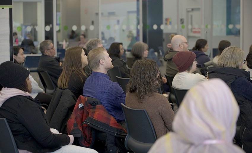 A crowd listening to a talk in the Visualization Lounge.