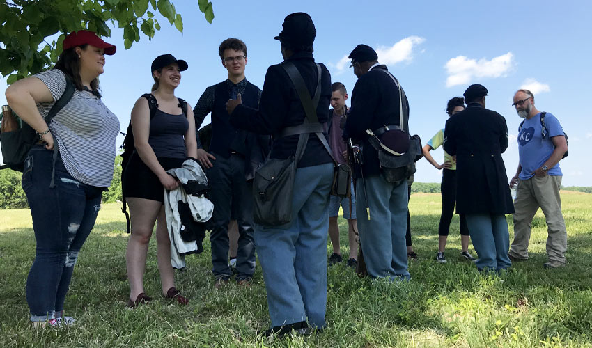 Students and Prof. Joe Anderson (far right) hear from guides at Chancellorsville Battlefield.