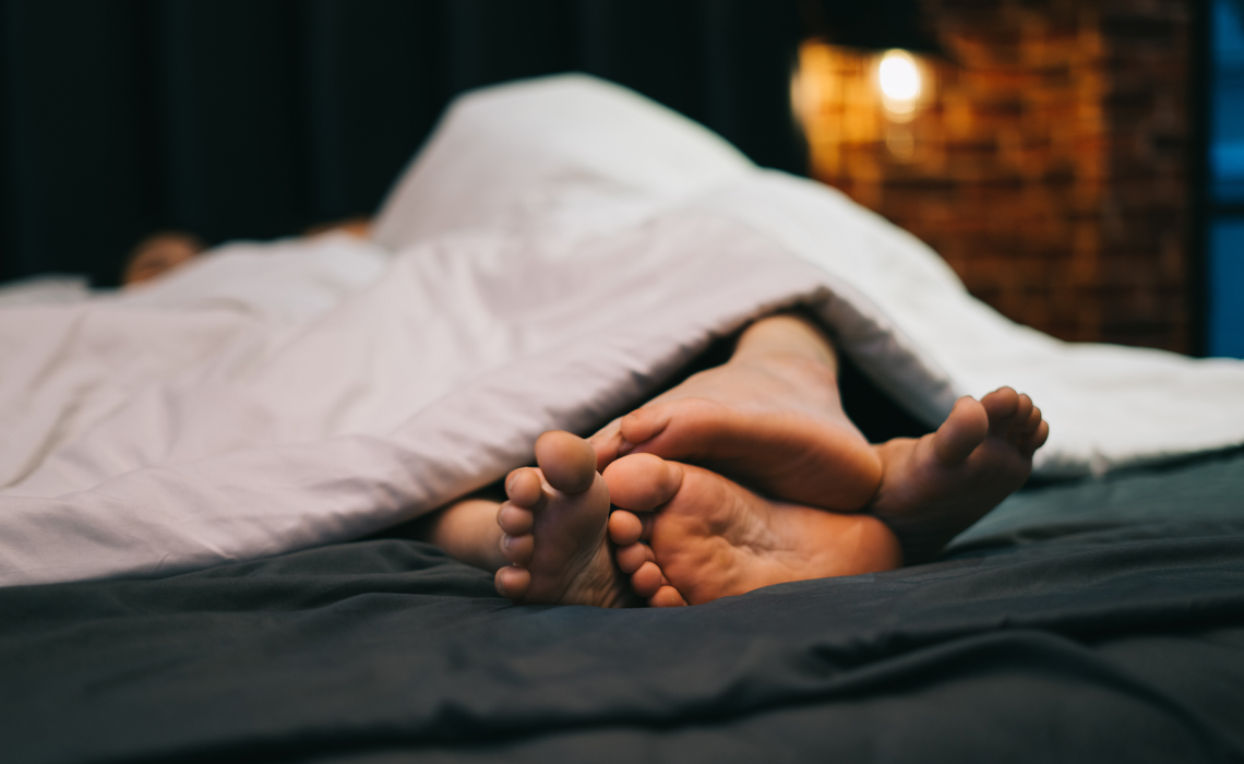 A couple on a bed.