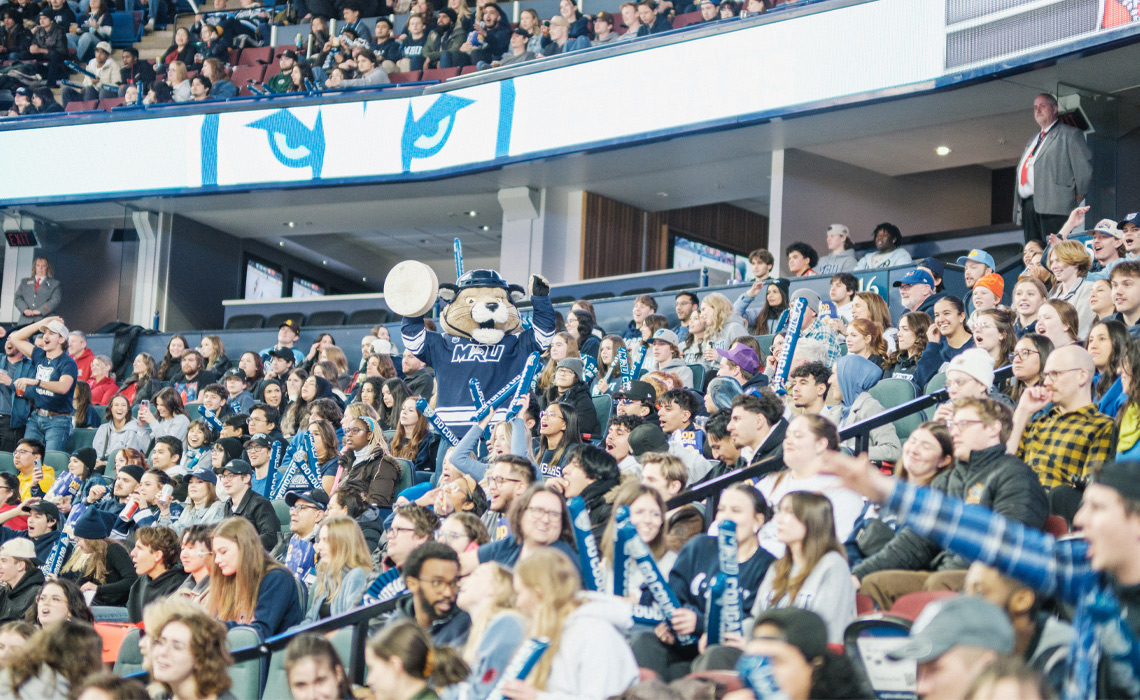 A lively crowd at the Crowchild Classic as Calvin the Cougar entertains.