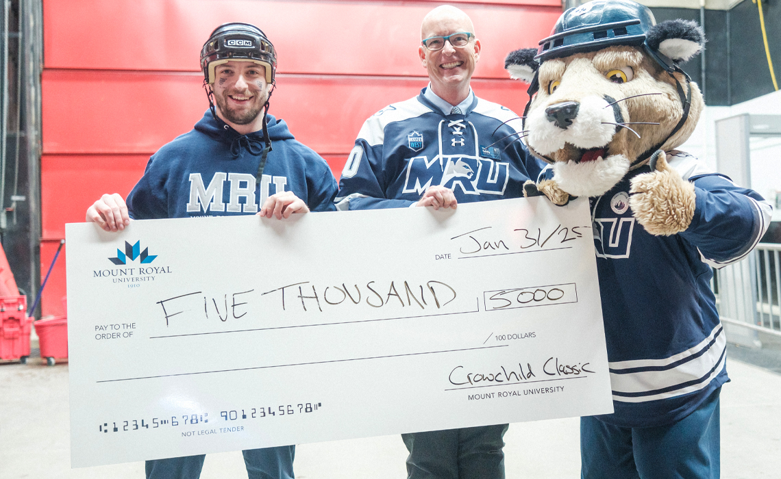 Bachelor of Education student Hunter Thudium, Dr. Tim Rahilly, PhD, president and vice-chancellor of Mount Royal University and Calvin the Cougar.