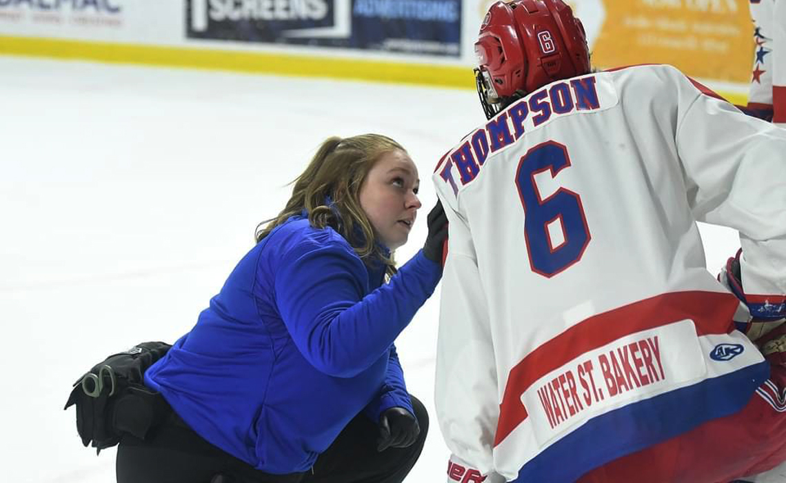 Athletic therapist Megan Drouin helping a Maritime Junior Hockey League player.