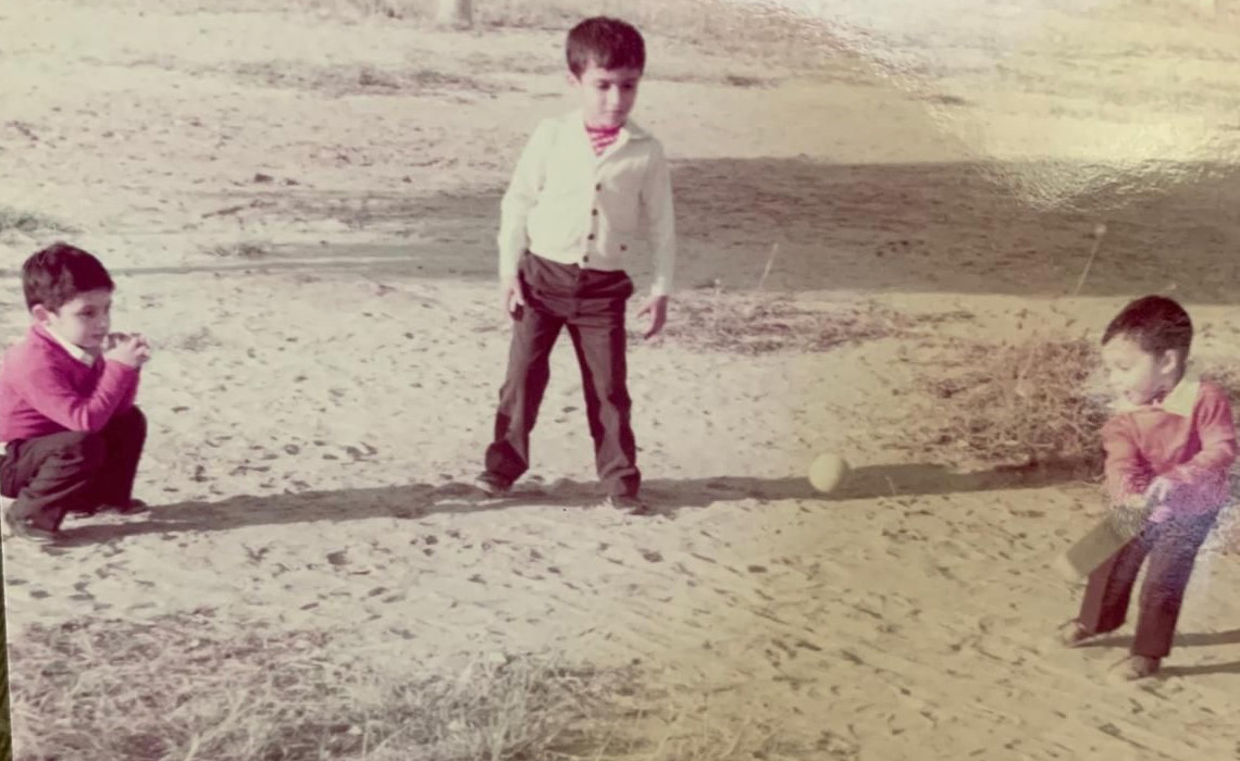 Nizar Punjani playing cricket with his two brothers in a neighbourhood park in his hometown of Karachi, Pakistan. 