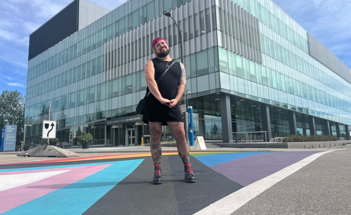 Sydney Morrissette poses for a photo outside the Riddell Library and Learning Centre.