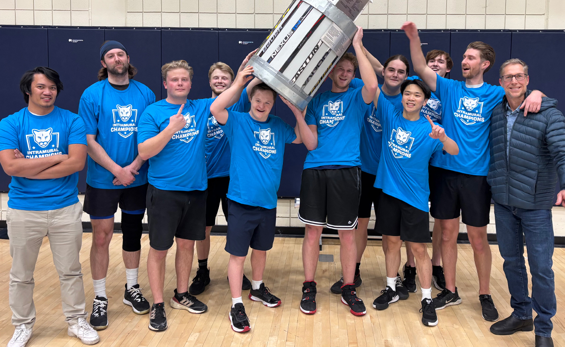 Wyatt Smuszko and his Team Swagger teammates hoisting the trophy for winning the Mount Royal intramural division championships.