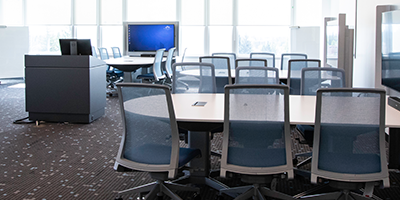 image of pod desks and an instructor's pedistal in the active learning classroom