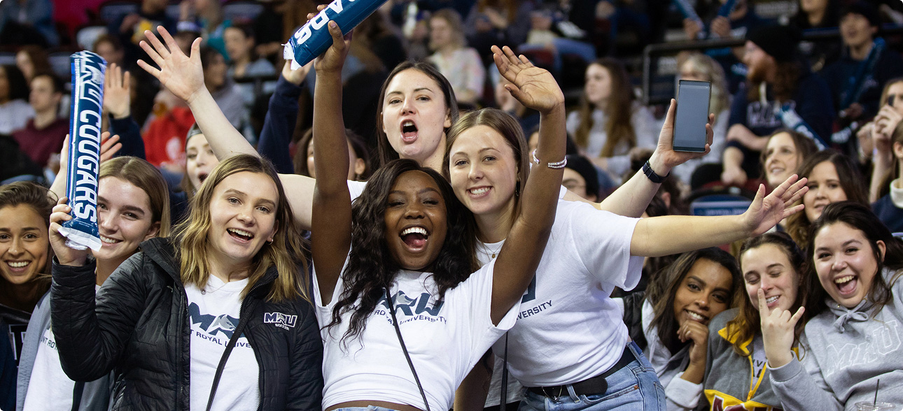 A group of Mount Royal University students cheering on the Cougar's at Crowchild Classic.