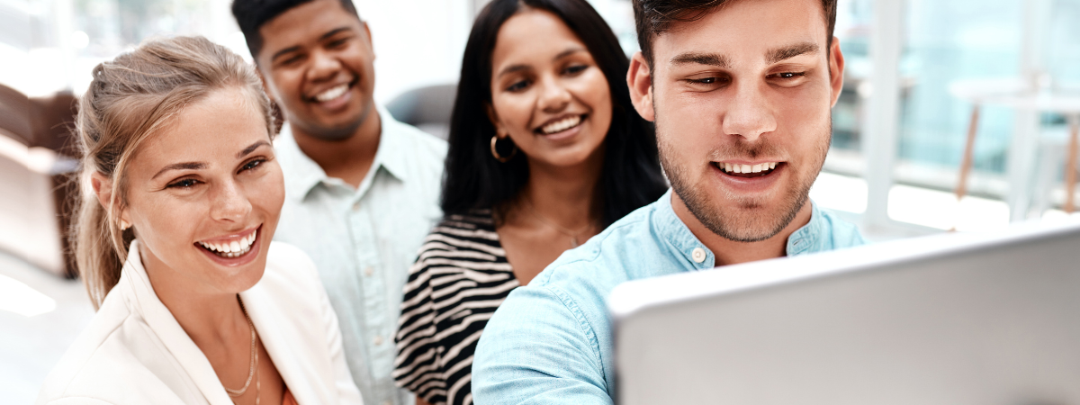 A group of young professionals looking at a screen.