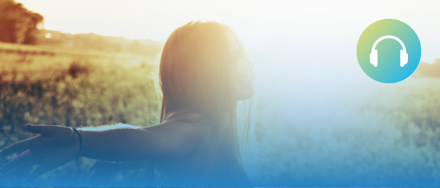 A woman with her arms out enjoying the outdoors.