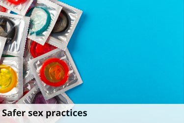 This image features several brightly colored, individually wrapped condoms scattered on the left side of the frame against a vibrant blue background. The right side of the image is empty, providing a clean contrast to the cluster of condoms. At the bottom of the image, there is a light blue strip with the text "Safer sex practices" in bold, black letters.