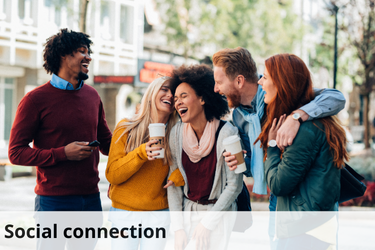 The image shows a group of five friends standing close together on a city street, laughing and enjoying each other's company. They are dressed in casual, colorful clothing and are holding coffee cups, suggesting a relaxed and friendly outing. The individuals appear to be engaged in a lively conversation, with smiles and laughter capturing the warmth of the moment. The image is captioned "Social connection," highlighting the importance of relationships and interactions with others for overall well-being. The setting and expressions emphasize the joy and positivity that come from strong social bonds