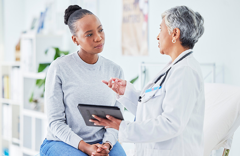 A medical professional explaining a procedure to a patient.