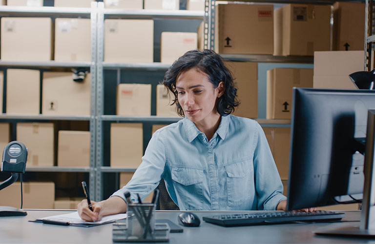 Professionals analyze inventory data in a warehouse.