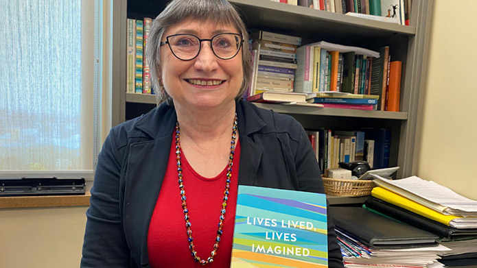 Dr. Sabrina Reed, PhD, displays book 'Lives Lived, Lives Imagined'
