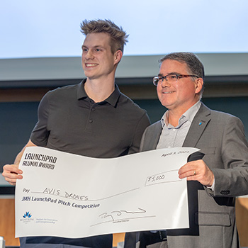 Charter Beselt accepting his win at the JMH LaunchPad Pitch Competition