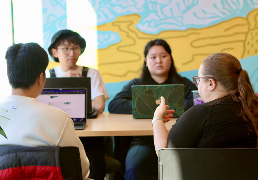 Group of people in the Slate Innovation Lab having a conversation.