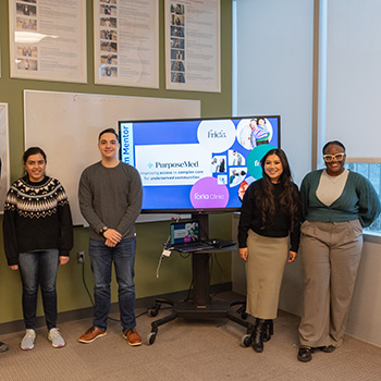 Hibba Zia's Innovation Sprint team posing in front their presentation on a screen.