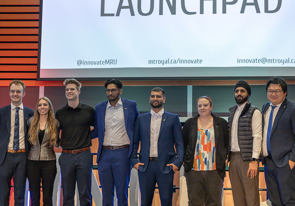 Participants of the JMH LaunchPad Pitch Competition lined up on stage in Ross Glen Hall.