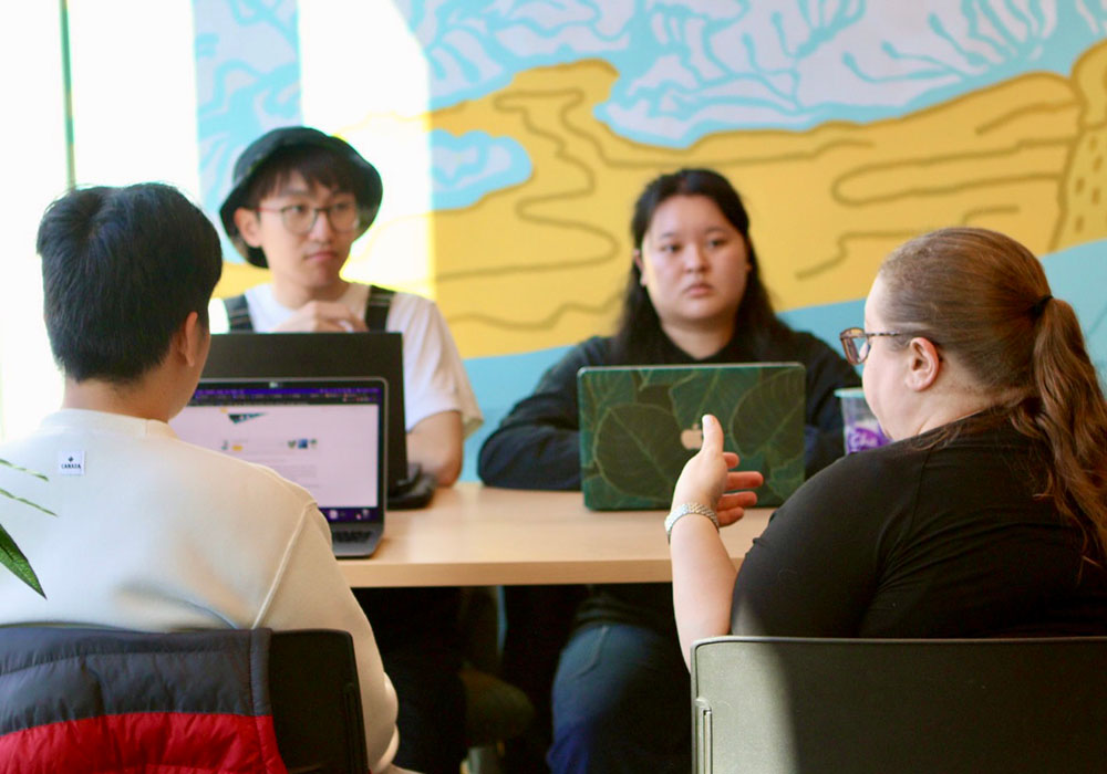 A group working at a table in the Slate Innovation Lab.