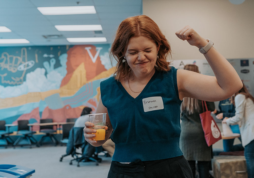 A woman pumping her fist in the Slate Innovation Lab.