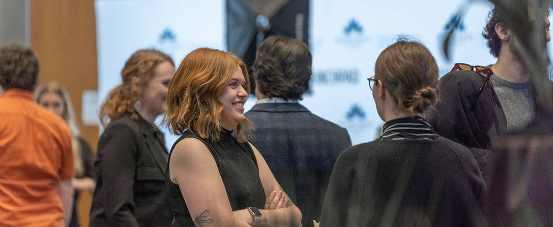 A group of people socializing at a networking event.