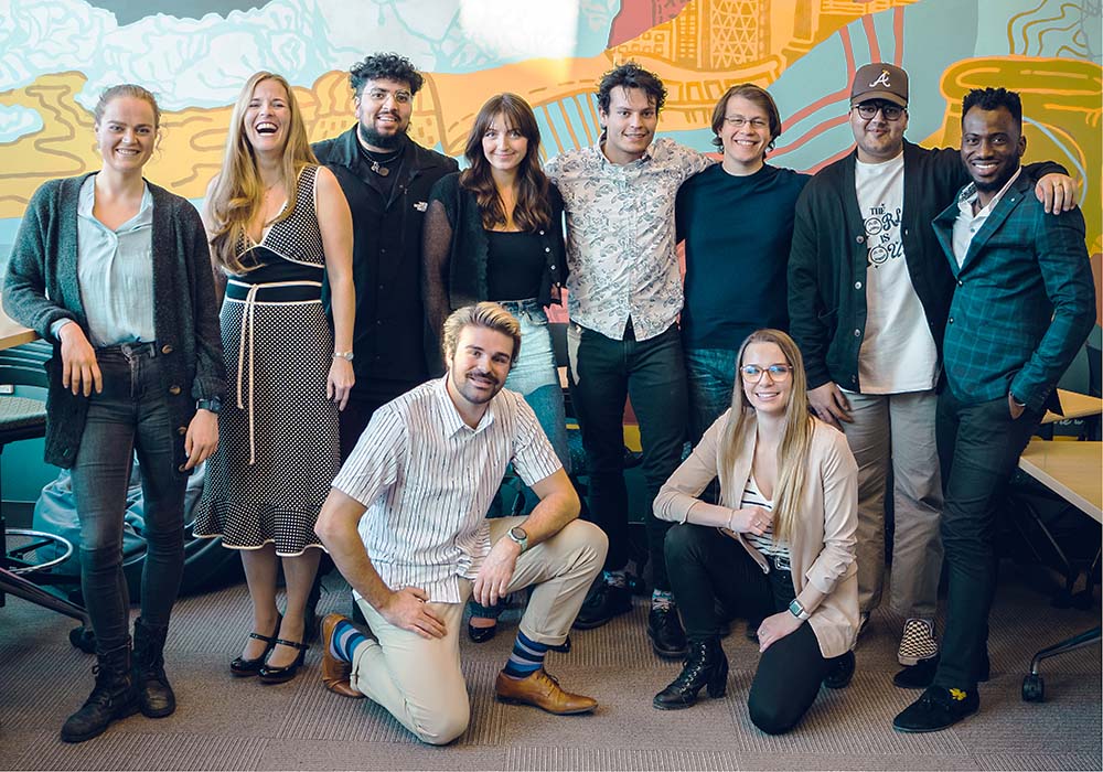 A cohort of Ideas Lab participants posing in the Slate Innovation Lab.