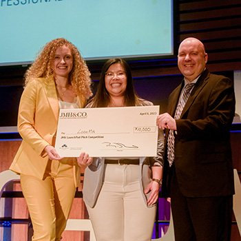 Rowan Dymond and Carman Lim accepting their JMH LaunchPad Pitch Competition win