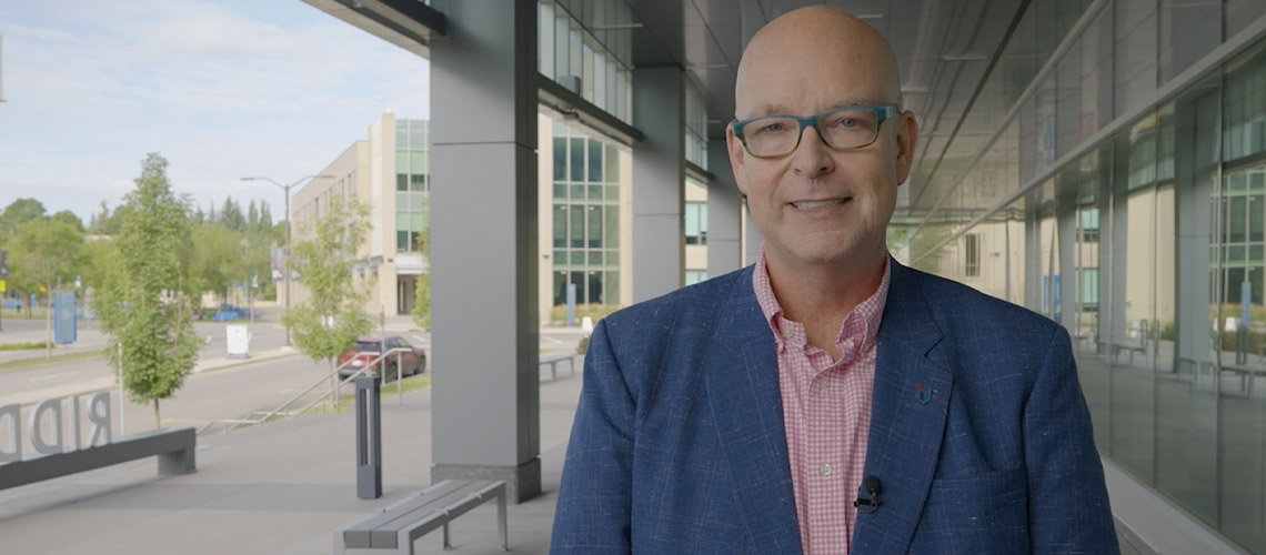 MRU president Tim Rahilly standing outside the Riddell Library and Learning Centre